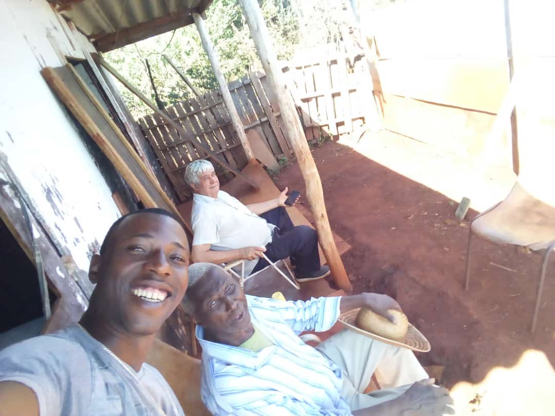 Cuidador da Anjo do Conforto ao lado de pacientes idosos, sorrindo